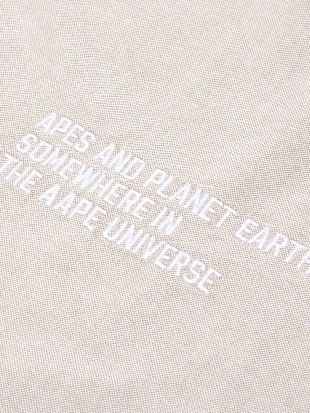 Moonface-embroidered cotton shirt