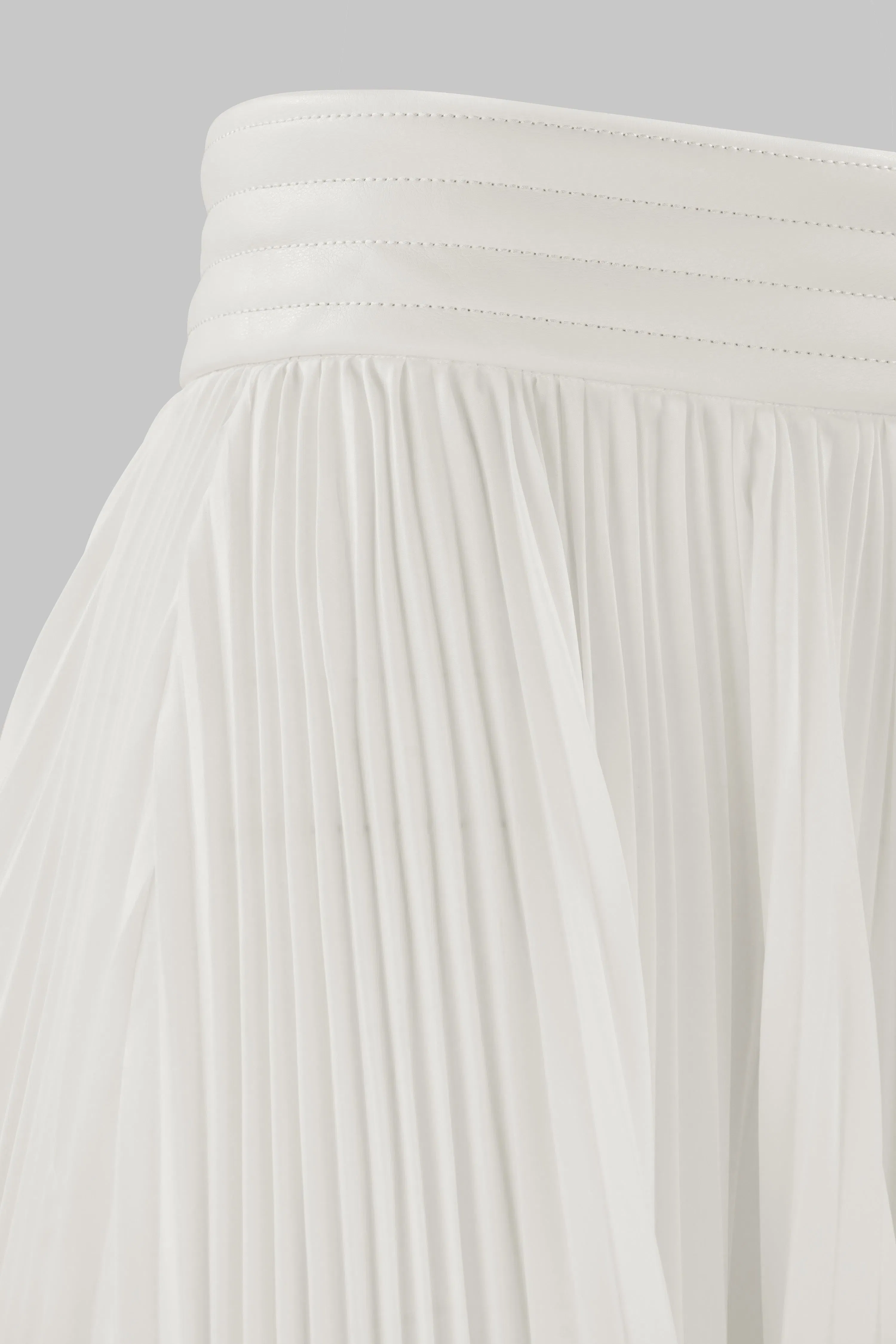 ASYMMETRIC PLEATED SKIRT W/ VEGAN LEATHER WAIST