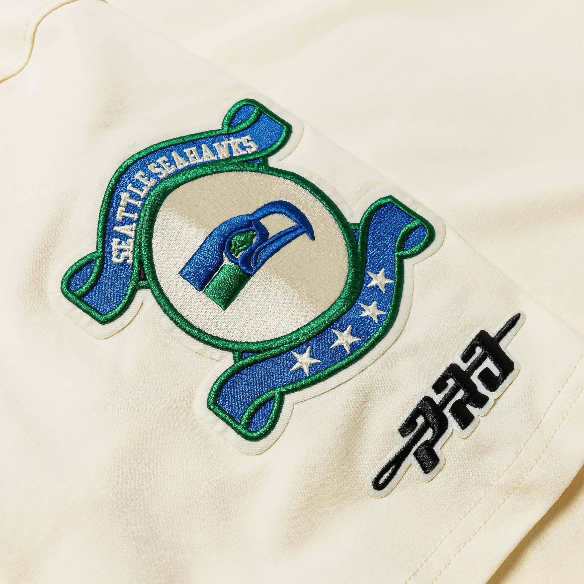 PRO STANDARD Seattle Seahawks Modern Originals Ringer Mens Short Sleeve Shirt (Beige/Blue)
