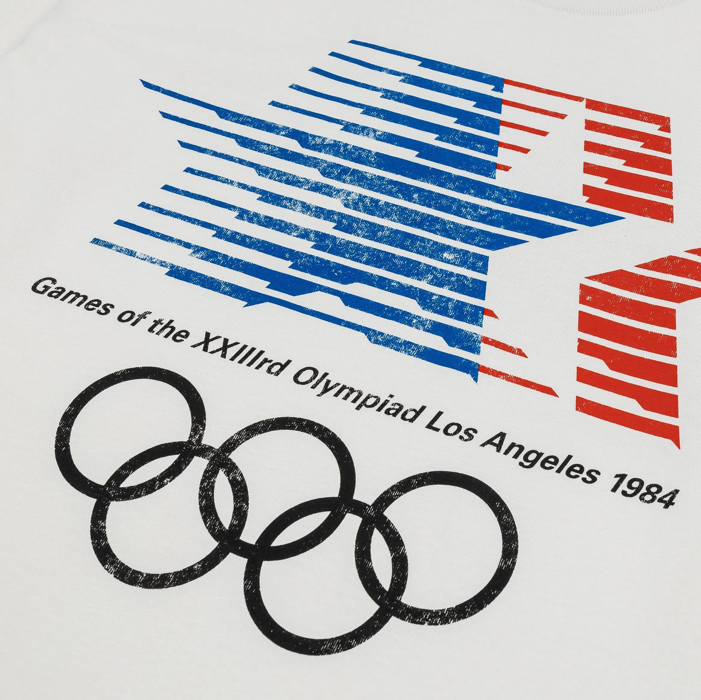 OUTERSTUFF 1984 Los Angeles Games Olympic Heritage Mens Short Sleeve Shirt (White/Blue)