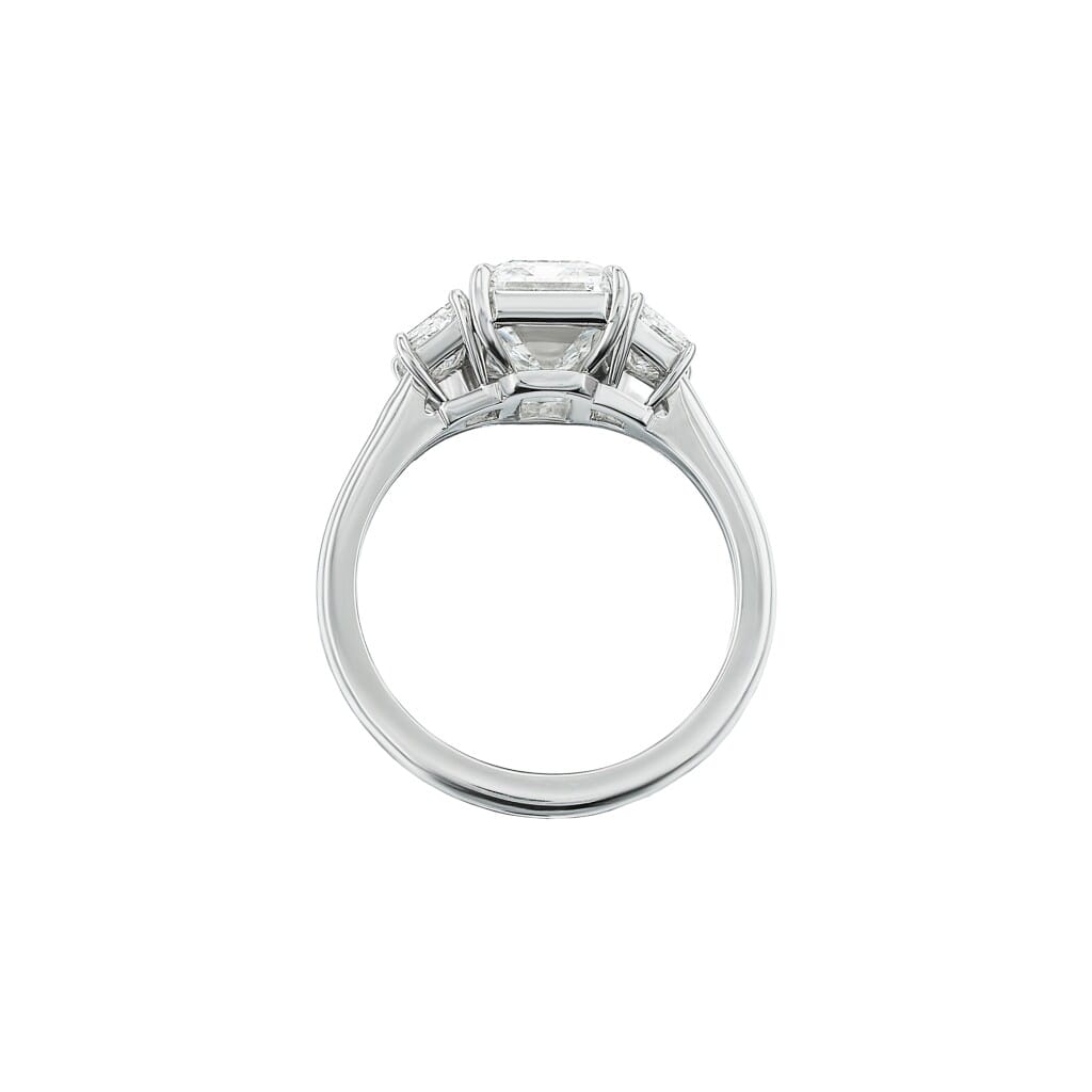 Platinum and 4.02ct Emerald Cut Diamond and Diamond Three Stone Engagement Ring
