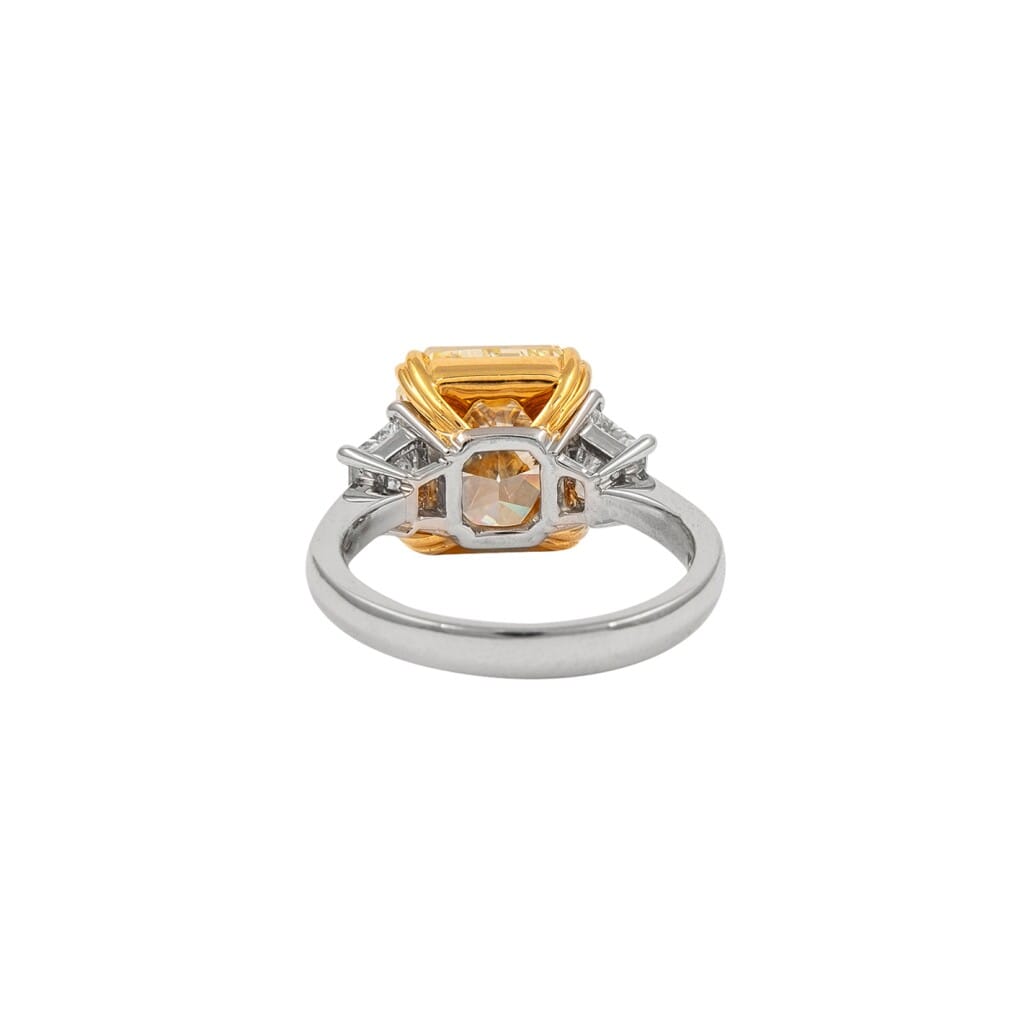 Platinum, Gold, 5.04ct Radiant Cut Fancy Yellow Diamond and Diamond Engagement Three Stone Ring