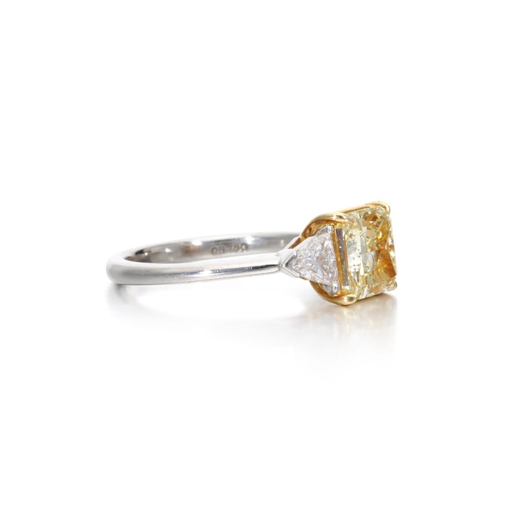 Platinum, Gold, 2.03ct Radiant Cut Fancy Yellow Diamond and Diamond Three Stone Ring