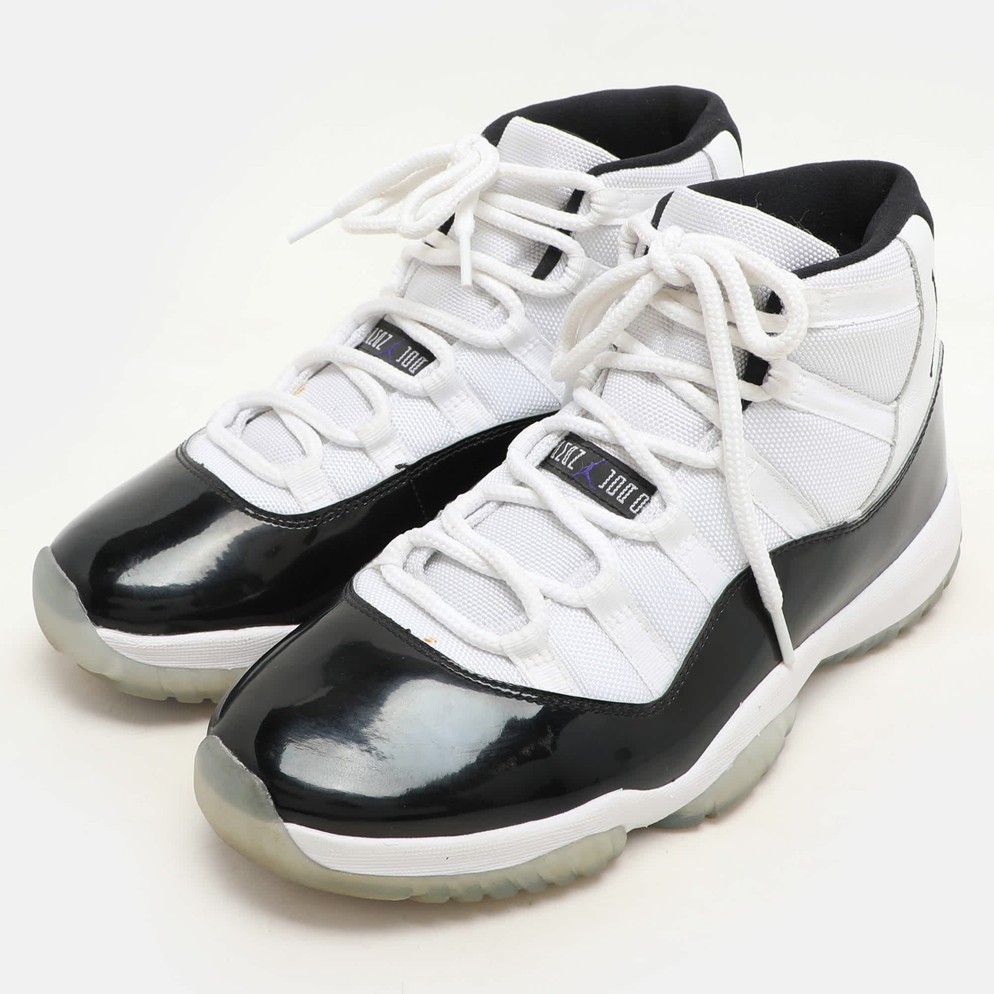 Air Jordan White/black Patent And Canvas Jordan - 11 - Retro High Top Sneakers