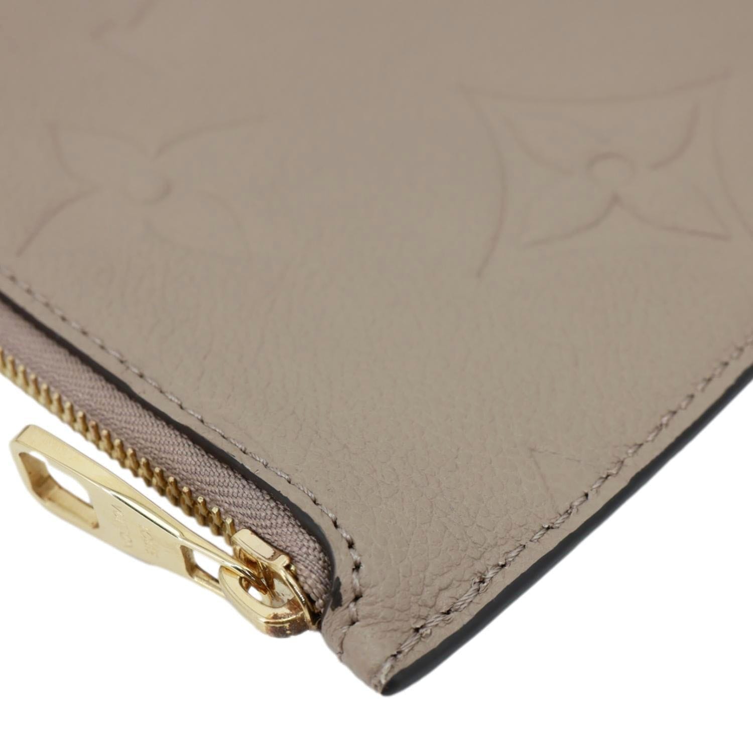 LOUIS VUITTON Neverfull Pochette Giant Monogram Empreinte Leather Wristlet Beige
