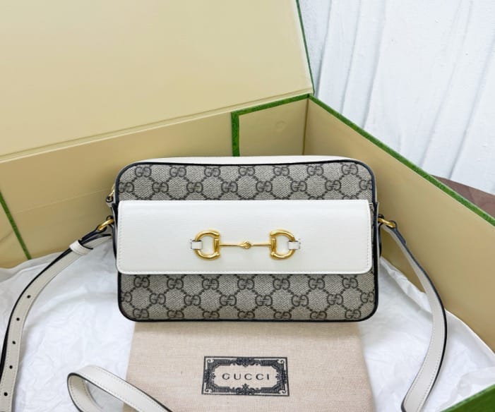 Gucci white monogrammed 1955 horsebit camera bag, priced at 22.5. 21677677