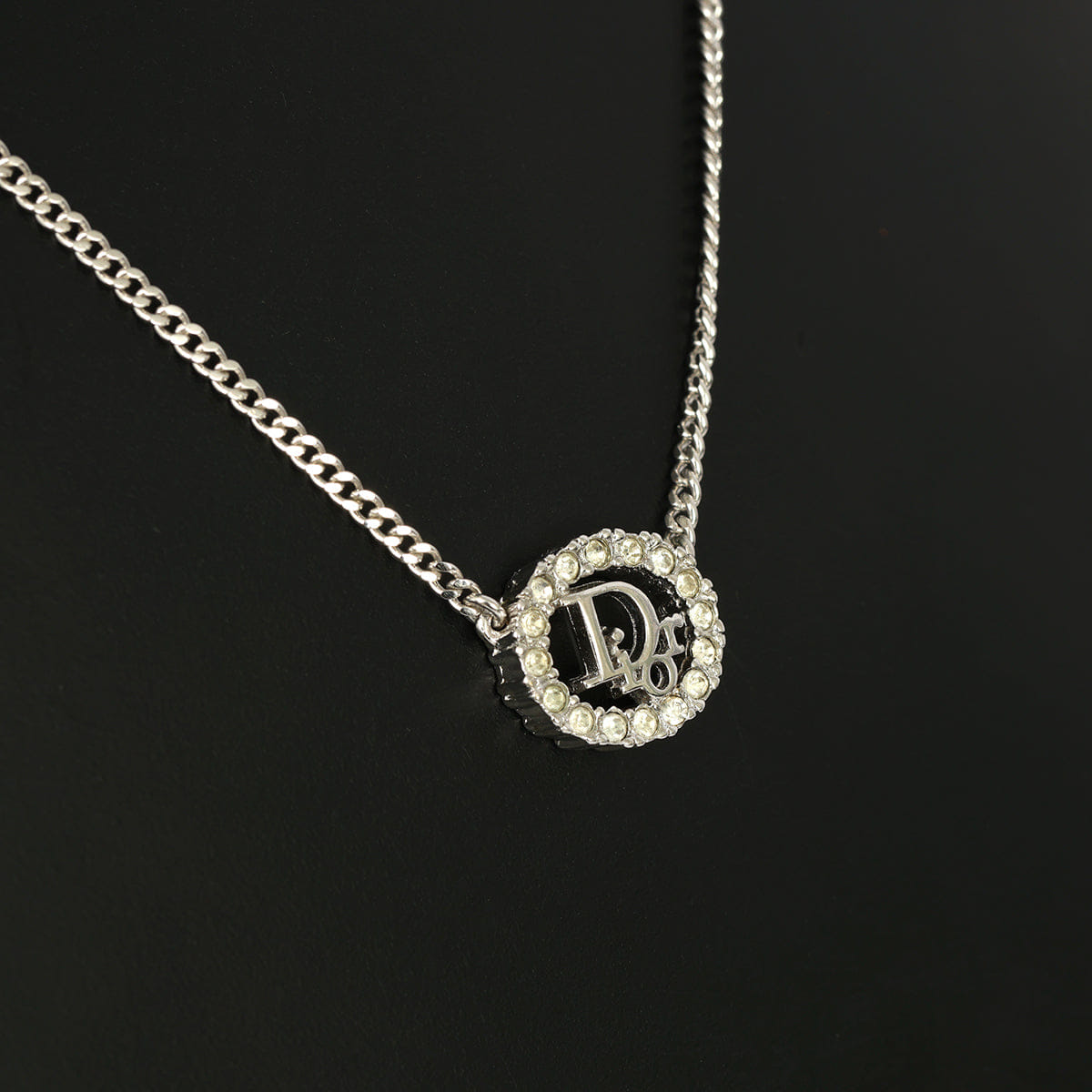 CHRISTIAN DIOR SILVER - TONE OVAL PENDANT WITH CRYSTAL DIOR LOGO