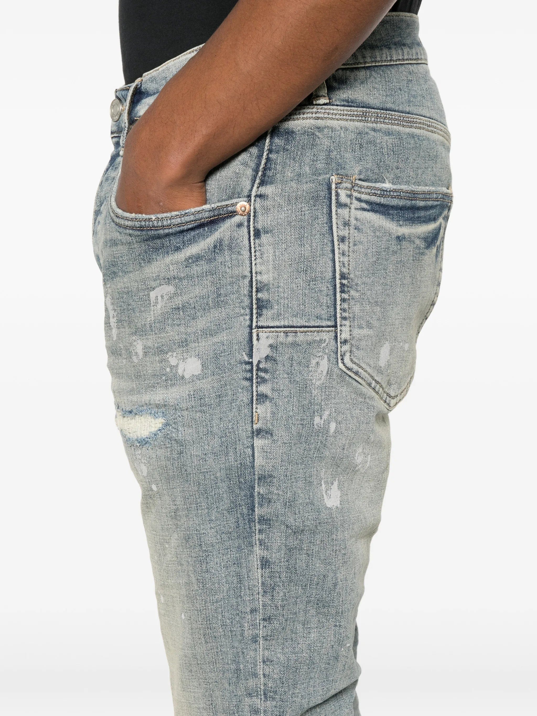 Purple Brand slashed paint jeans