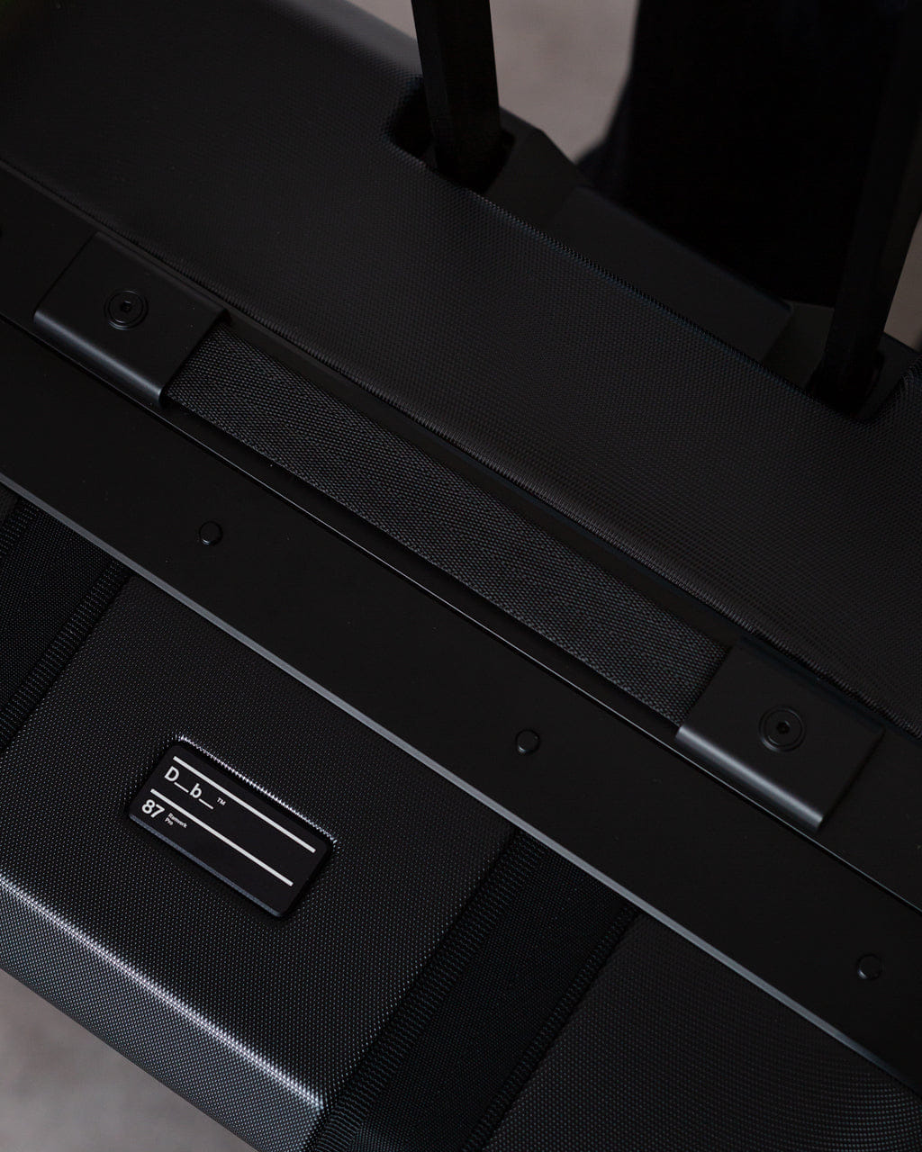 D_b_ Ramverk Pro Check - in Luggage - Black Out