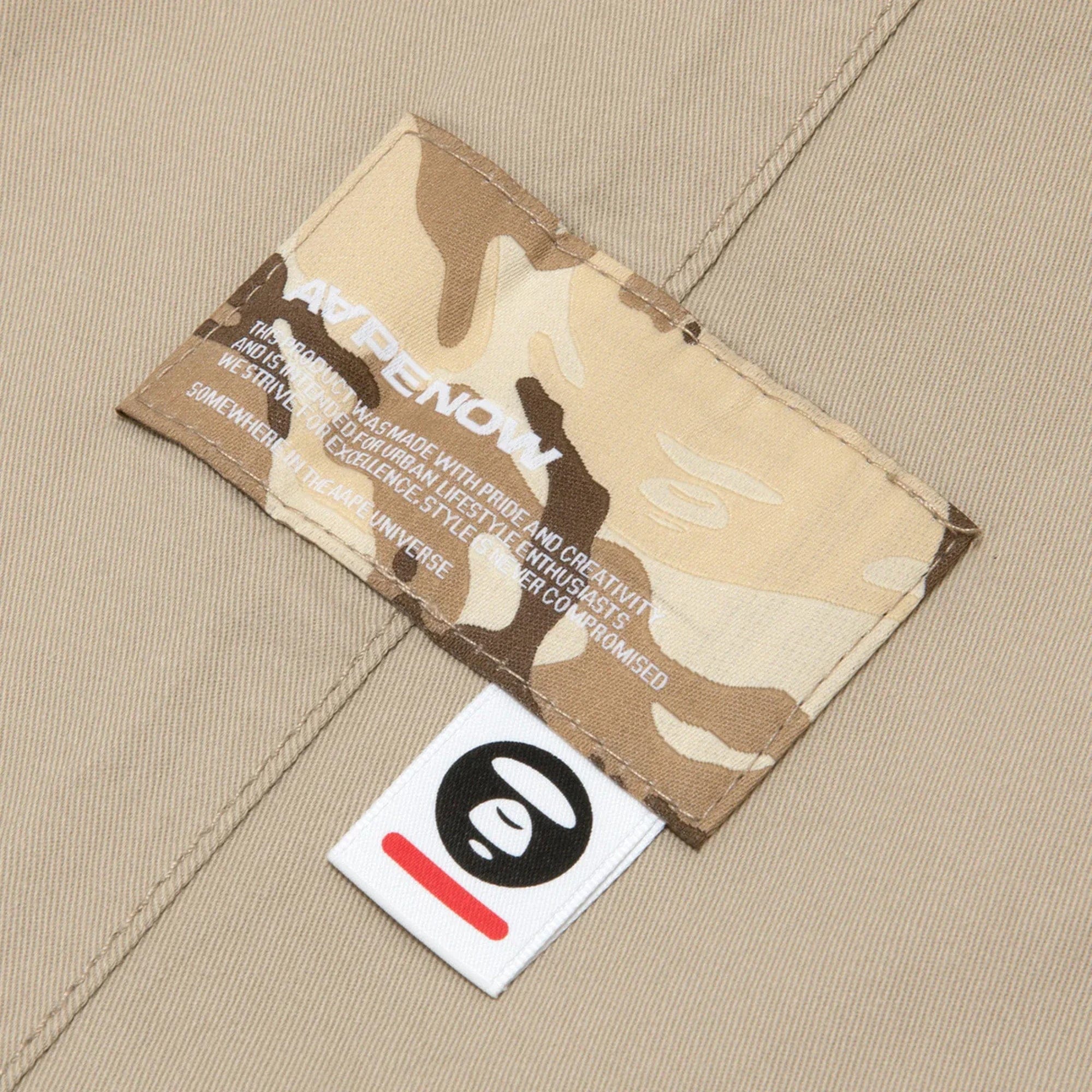 AAPE by A Bathing Ape AAPE Moonface Embroidered Relaxed Woven Pants Beige / Grey