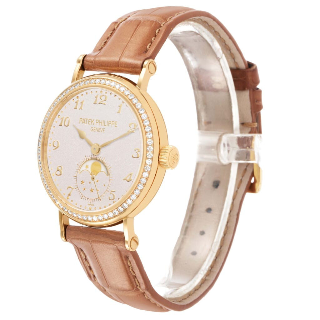 Calatrava (Reference 7121J). A 33mm yellow gold diamond-set manual wind wristwatch with moon phase.
