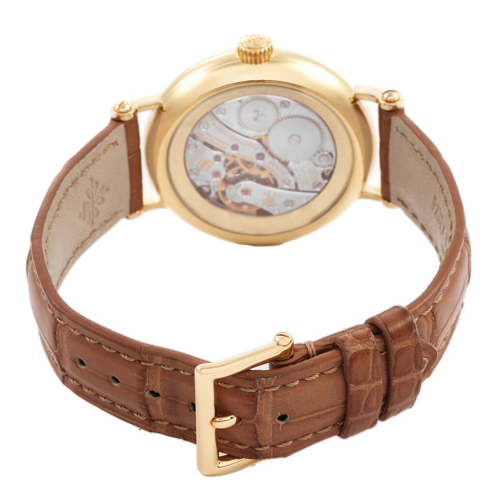 Calatrava (Reference 7121J). A 33mm yellow gold diamond-set manual wind wristwatch with moon phase.